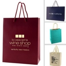 Paper bags in multiple solid colors, ranging from Kraft to Laminated European Tote Style Bags.